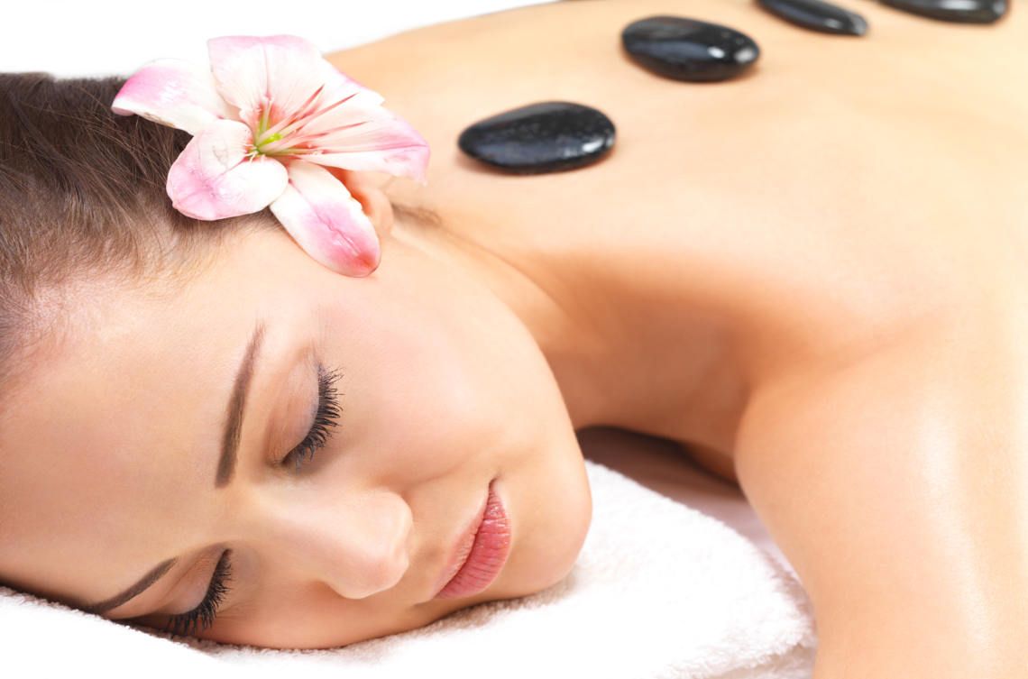 Warm stones on a relaxed back